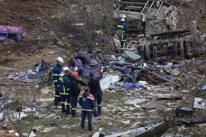 Personal de emergencias trabaja junto a los restos de uno de los trenes siniestrados, este miércoles.