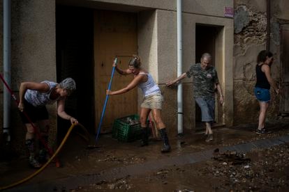Varios vecinos trabajan en las zonas afectadas por las lluvias, este domingo en Santa Barbara (Tarragona).