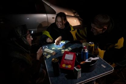 Tres asistentes franceses juegan al dominó, en la 'rave' celebrada en Fuente Álamo, este miércoles.