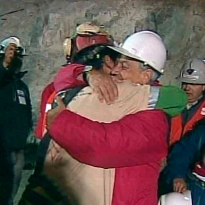In this screen grab taken from video, Florencio Avalos, the first miner to be rescued, left, is embraced by Chilean President Sebastian Pinera after his rescue Tuesday, Oct. 12, 2010 at San Jose Mine near Copiapo, Chile. (AP Photo)