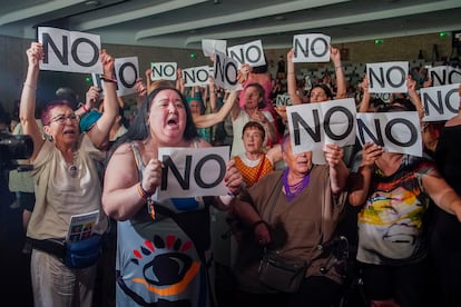 El público y supervivientes del Patronato de Protección a la Mujer sujetan carteles de protesta durante el acto en la Fundación Pablo VI en Madrid.